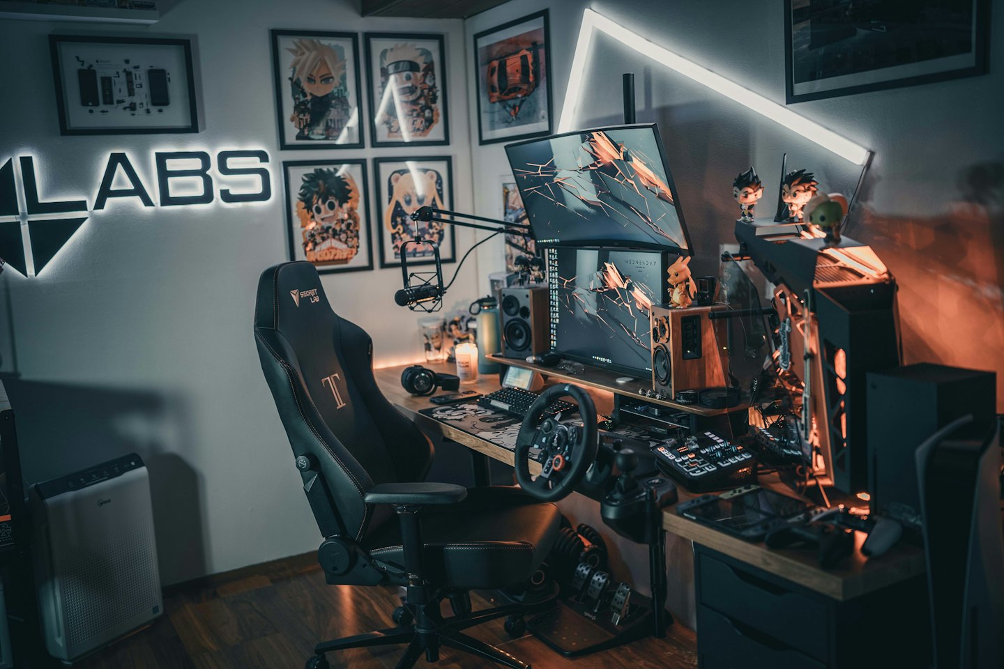 Gaming workstation featuring multiple monitors and a steering wheel.